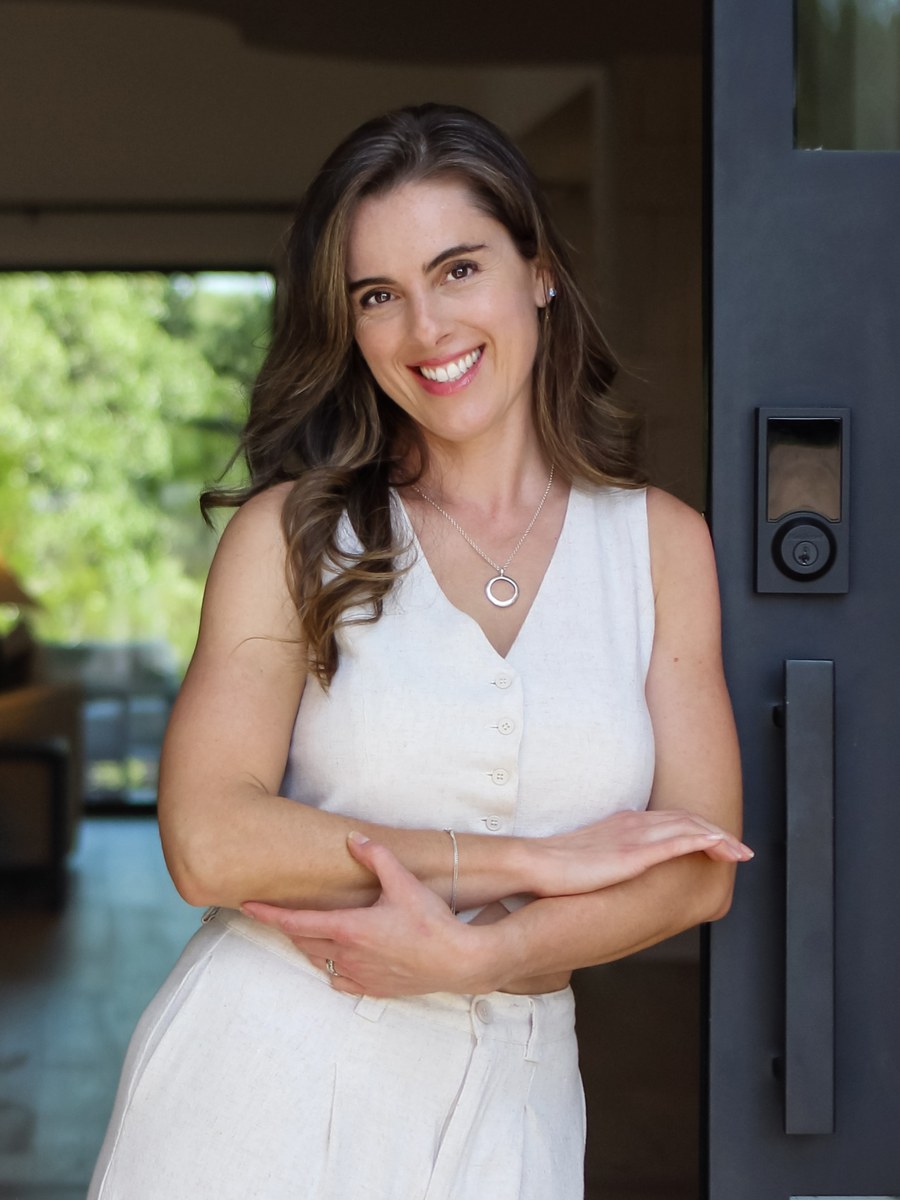 Evelyn Vallin, REALTOR®, at the front door of a home in the Austin area